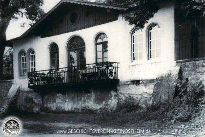 Das Foto zeigt den Pavillon des Marienhofs im Jahre 1962. Man kann deutlich erkennen, dass der Mainuferweg erheblich tiefer lag als heute. Durch den Bau der Schleuse (1966 – 1971) stieg der Wasserspiegel des Mains oberhalb des Wehrs um 2,50 m an, sodass sich der Uferweg heute in gleicher Höhe wie der Pavillon befindet.