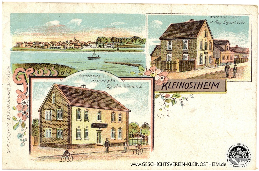 Litho-Ansichtskarte mit dem Gasthaus zur Eisenbahn (Georg Anton Wienand) und dem Warengeschäft von August Eizenhöfer (Bahnhofstraße), gelaufen am 29. September 1909.